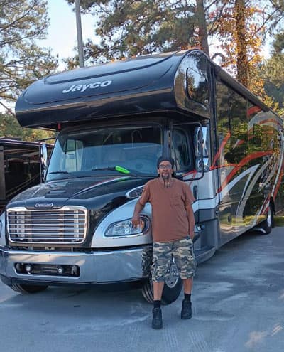 Man standing in front of clients camper