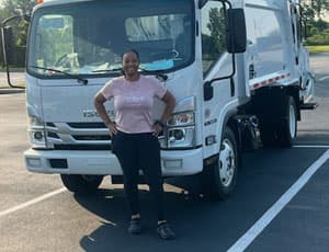 Woman standing in front of their white van.